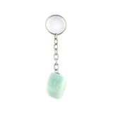 Amazonite keychain, tumbled green-blue stone attached to silver keyring on white background.