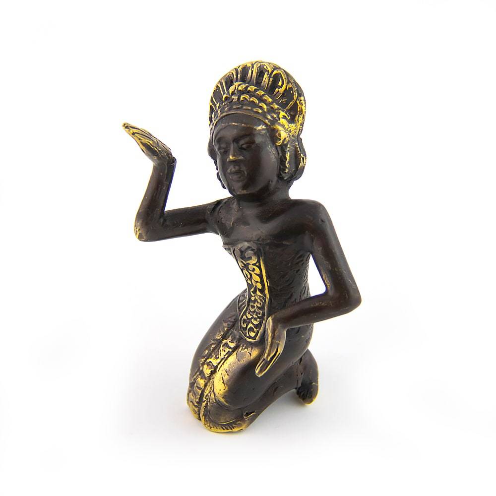 Angled view of brass figurine of a kneeling dancer with ornate headdress and graceful hand pose on white background.