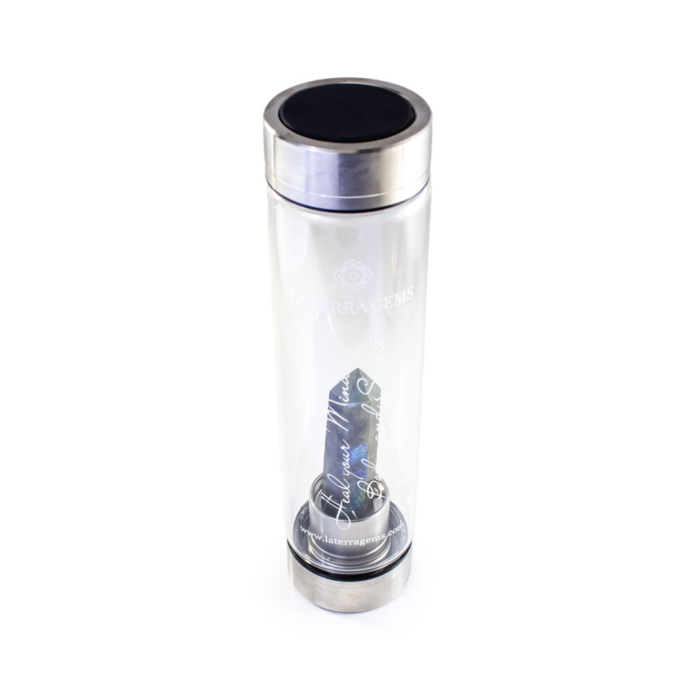 Gemini Laterra Gemstone Water Bottle with labradorite crystal attachment inside clear glass bottle on white background.