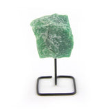 Raw green quartz crystal on black metal display stand, front-facing on white background.