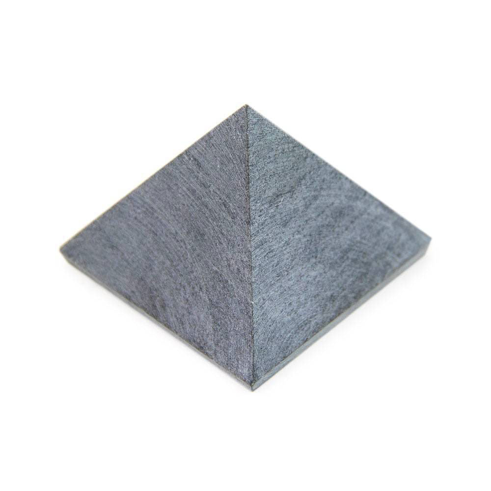 Soapstone pyramid, angled close-up showing raw matte finish and detailed texture.