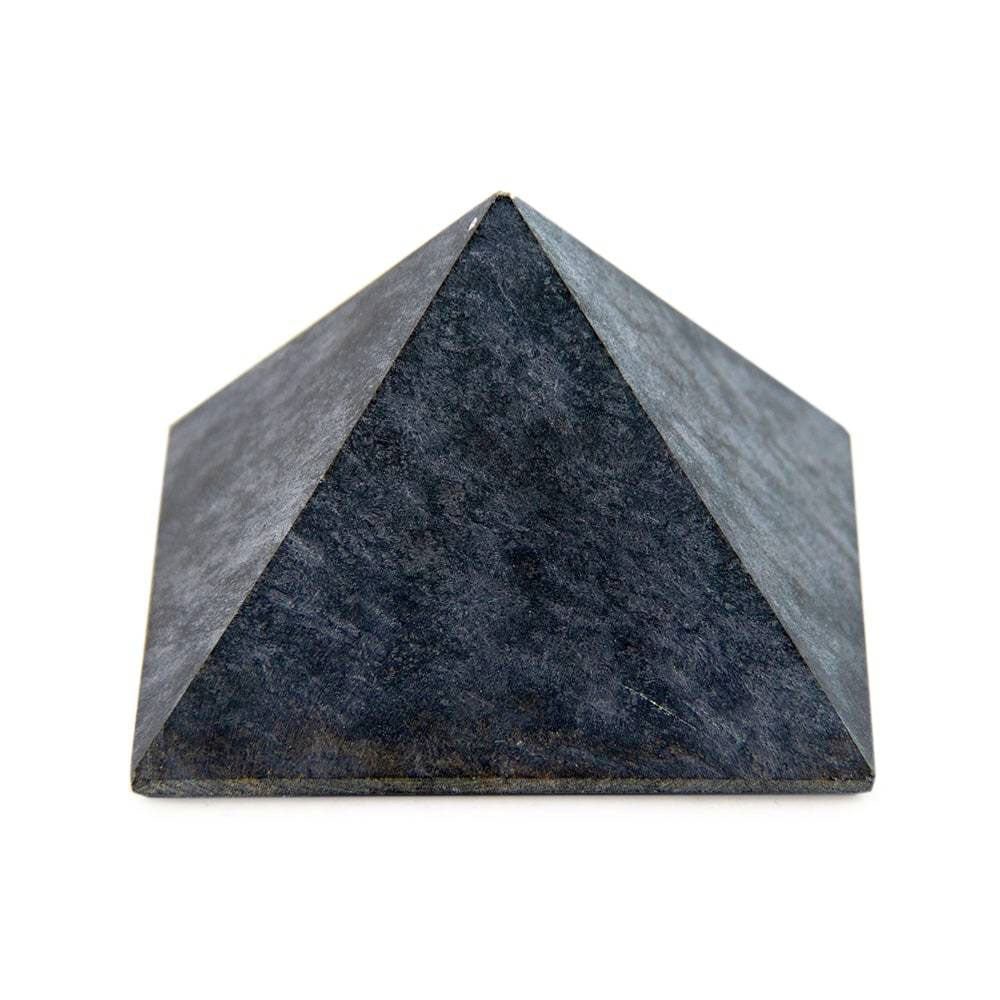 Soapstone pyramid, side view showing smooth edges and natural stone grain.