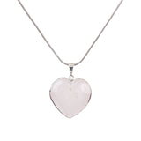 Close-up of Rose Quartz Heart Pendant showing polished stone in silver tone frame.
