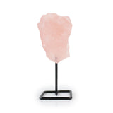 Raw rose quartz crystal displayed on a metal stand for home decor, front view against white background.