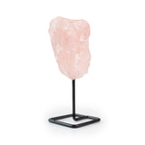 Raw rose quartz on metal stand for home decor, angled view of right side against white background.