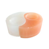 Front view of Selenite Yin Yang Candle Holder made from white and peach selenite interlocking halves with tealight openings.