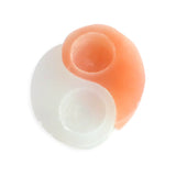 Top view showing texture and contrast between white and peach selenite Yin Yang candle holder pieces.