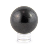 Polished shungite sphere on a white background.