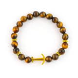 Unisex tiger eye beaded bracelet with gold anchor charm symbolizing strength and stability.