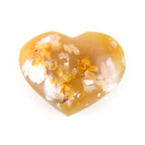 Polished agate heart stone, front view, natural colors on white background.