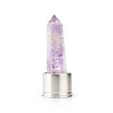 Amethyst attachment for Laterra Gemstone Water Bottle, polished crystal point in metal base on white background.