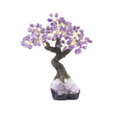 Large Amethyst bonsai tree sculpture with tumbled amethyst leaves on raw amethyst foundation.