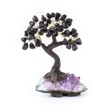 Medium black onyx bonsai tree with tumbled black onyx leaves on raw amethyst base.