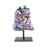 Large rainbow titanium quartz on black metal base, front facing, colorful iridescent quartz cluster on white background.