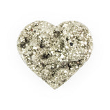 Raw pyrite heart crystal with rough texture on a white background