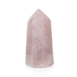 Rose quartz point, side view showing smooth facets and subtle transparency.