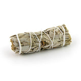Small sage smudge stick isolated on white background for cleansing and purification.