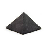 Shungite pyramid, angled view highlighting geometric shape and natural texture.