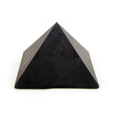 Shungite pyramid, side view showing unpolished finish and symmetry.