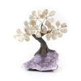 Small smoky quartz bonsai tree with tumbled gemstone leaves on raw amethyst crystal base.