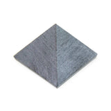 Soapstone pyramid, angled close-up showing raw matte finish and detailed texture.