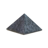 Soapstone pyramid, angled view highlighting organic surface and earthy colors.