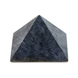 Soapstone pyramid, side view showing smooth edges and natural stone grain.